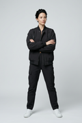 Sculpt Zip Bomber Jacket – front view of the zipped black bomber jacket, model with arms crossed, black trousers and white sneakers