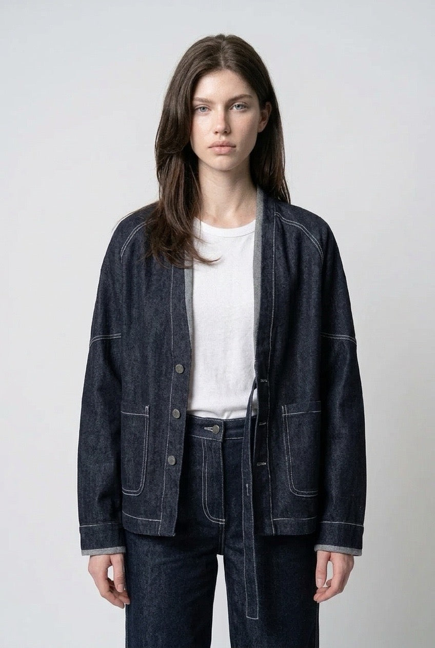 Close-up of the jacket front with white contrast stitching and the strap drawn out
