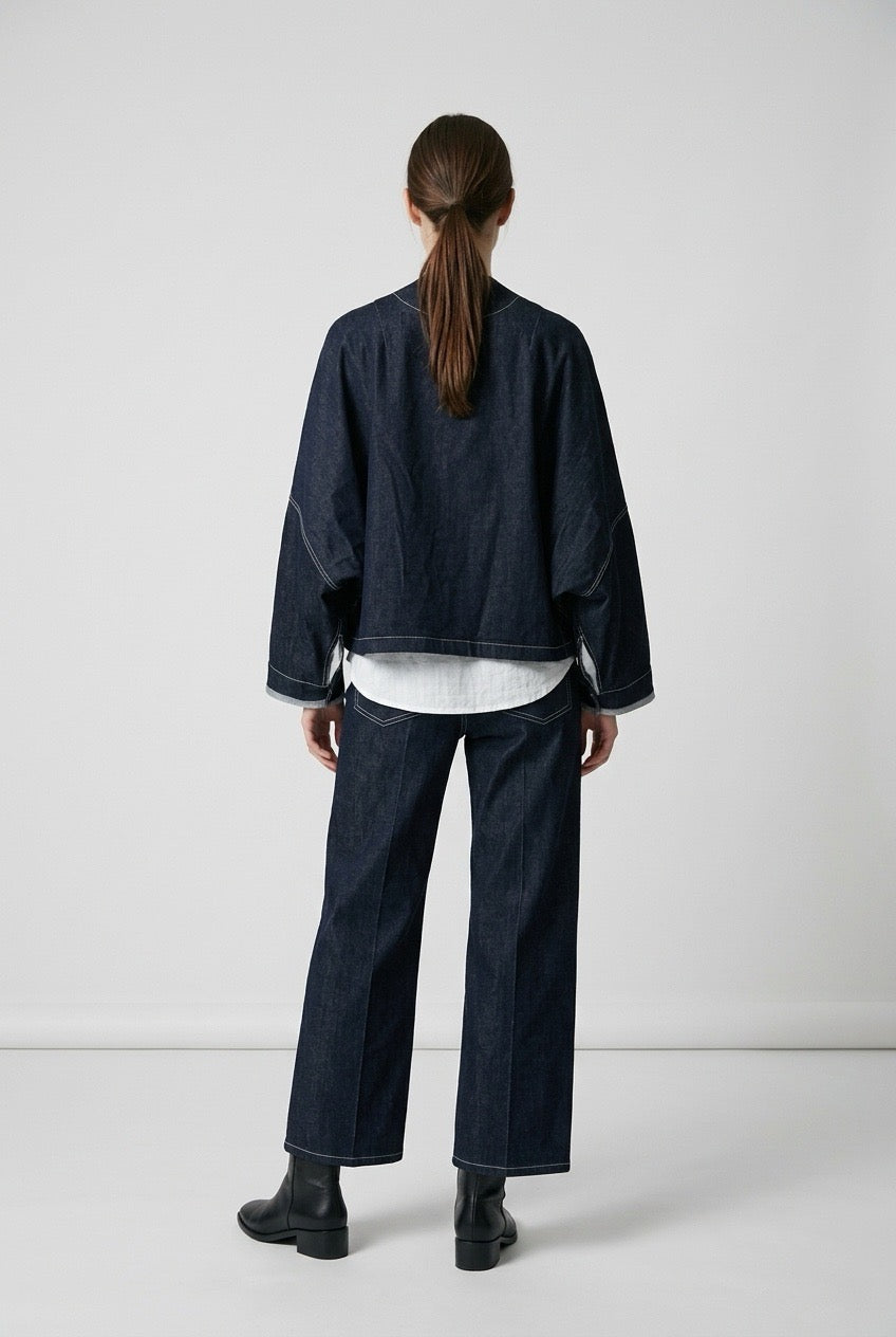 Back view of the oversized indigo denim jacket showing dropped shoulders
