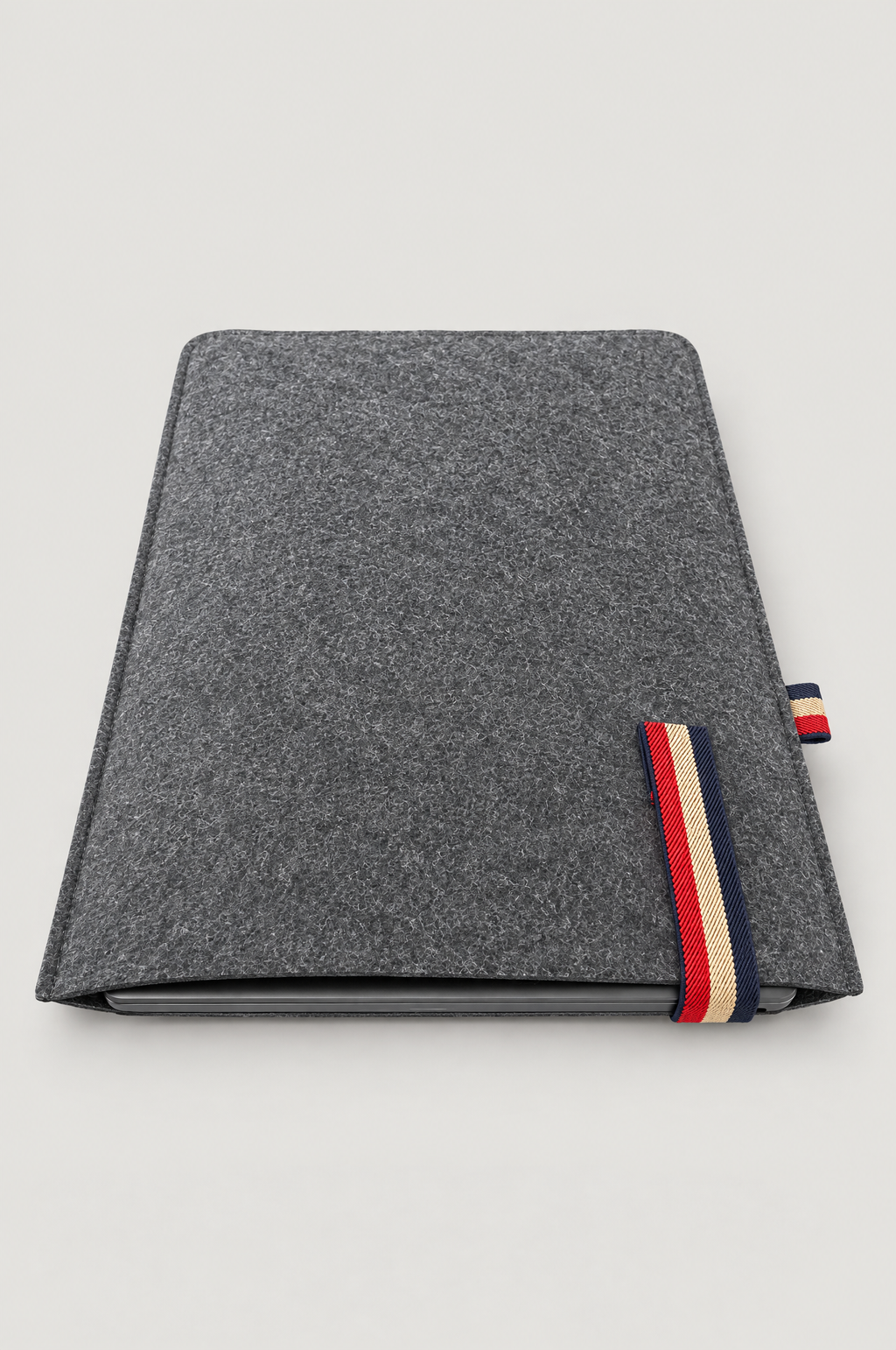 Charcoal felt laptop sleeve with laptop inside and red, beige and navy striped elastic band (laptop not included)