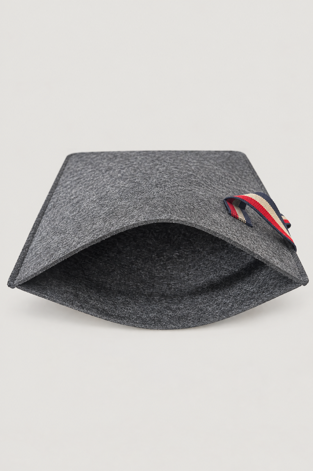 Charcoal felt laptop sleeve shown open with striped elastic loop