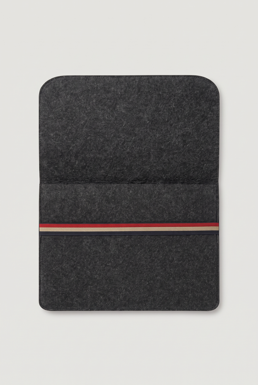 Charcoal felt laptop sleeve opened flat, showing the cover flap and red, beige and navy striped elastic band